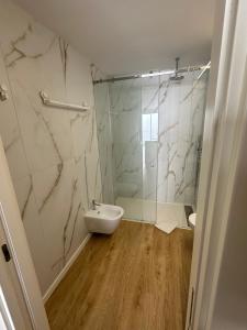 a bathroom with a shower and a toilet and a sink at New Douro Tower 305 with shared pool in Vila Nova de Gaia +11 photos