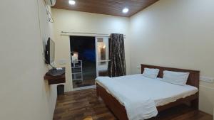 Ένα ή περισσότερα κρεβάτια σε δωμάτιο στο Madhurleela