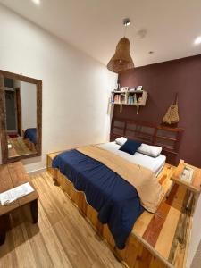 a bedroom with a large bed and a mirror at Hostel-John Cafe and Beer in Da Lat +101 photos