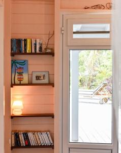 a door leading into a room with a window at La poolhouse in Grand-Bourg