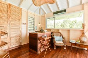 a home office with a desk and a chair at La poolhouse in Grand-Bourg