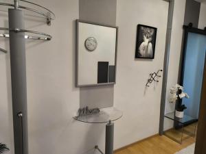 a room with a glass table and a mirror at 4 You Apartment in Leoben mit Balkon, Garten und kostenlosen Parkplatz in Leoben
