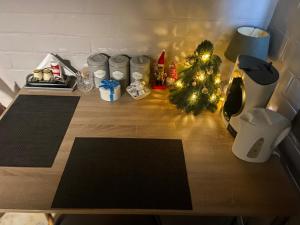 a table with a christmas tree and gifts on it at Toezens in Ingelmunster