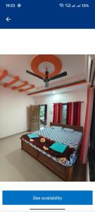 a picture of a bedroom with a bed at Divyesh Holiday Home in Nagaon +1 photo