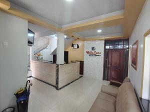 a living room with a couch and a kitchen at Hotel Val-de-Cans Aeroporto in Belém