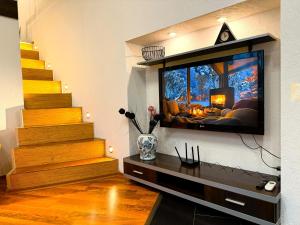 a living room with a tv on a wall at Kyiv Muse Apartment in Kyiv