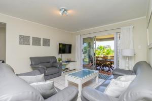 a living room with a couch and a table at Sea-Renity 10 in Umdloti +24 photos