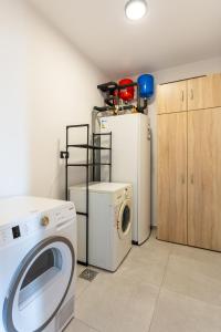 a laundry room with a washing machine and a washer at Hiša Urma in Celje +50 photos