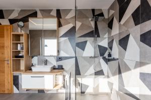 a bathroom with a sink and a shower at Hiša Urma in Celje