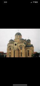 a tall brick building with a dome on top at Dion Luxury Apartaments in Gjilan