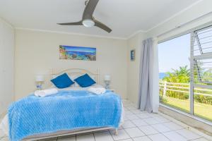 a bedroom with a bed with a view of the ocean at Sea-Renity 10 in Umdloti