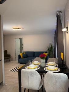 a living room with a table with chairs and a couch at Near Passage in Jelgava