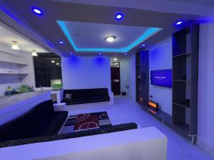 a living room with a couch and a tv at Panorama Housing Complex in Addis Ababa
