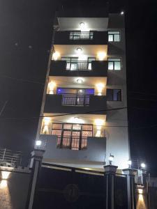 a tall building at night with lights on it at Panorama Housing Complex in Addis Ababa +10 photos
