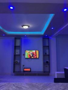 una camera con TV a parete con luci viola di Panorama Housing Complex ad Addis Abeba