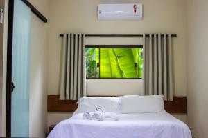 Ένα ή περισσότερα κρεβάτια σε δωμάτιο στο Refúgio Rosa do Mar +35 φωτογραφίες