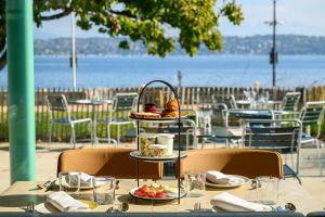 a table with a plate of food on top at Auberge Port Gitana in Bellevue