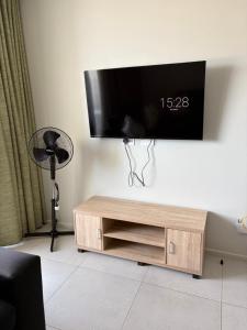 a flat screen tv hanging on a wall at Flat 4 Block 12 Bellamare in Port Elizabeth