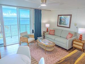 a living room with a couch and a view of the ocean at Beachfront Studio w Amazing Views in Hauula