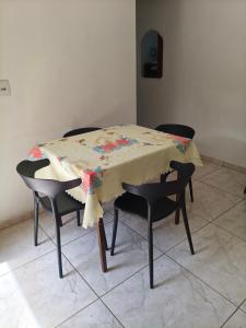 a table with chairs and a table cloth on it at Mini lar próximo ao parque in Caparaó Velho +3 photos
