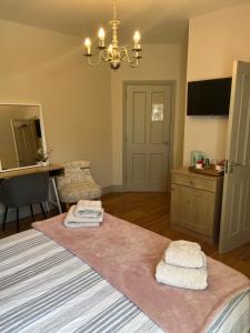a bedroom with a bed with two towels on it at clover cottage in Kinsale