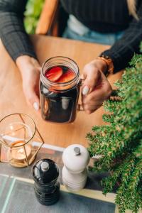 a person holding a jar of jam on a table at Hotel Mokotów in Warsaw