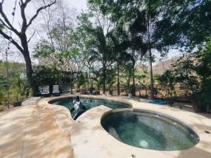 a swimming pool in the middle of a yard at Hacienda La Luna Luxury Private Villa in Potrero