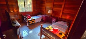 a small room with a bed and a table at Wooden House in Maria da Fé