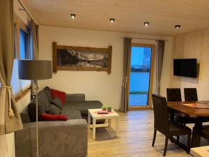 a living room with a couch and a table at Chalet Fügen in Fügen
