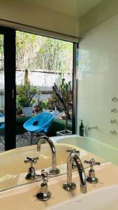 a bathroom with a sink and a mirror at Melbourne suites - Zen Oasis or skyline views in Melbourne +26 photos