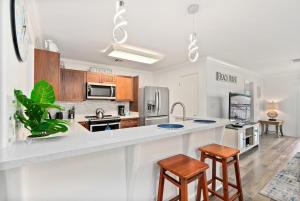 a kitchen with a counter and two stools at Island Paradise Resort Villa in Honokai Hale +43 photos