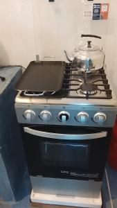a stove with a pot on top of it at Hostel Casa escondida in Santa Cruz La Laguna