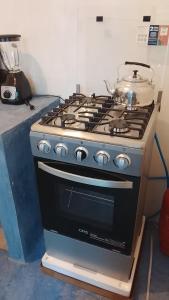 a stove with a pot sitting on top of it at Hostel Casa escondida in Santa Cruz La Laguna