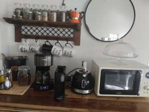 a kitchen counter with a microwave and a mirror at Αγροτικό σπίτι agrikia με θέα στο βουνό πάρκινγκ και δωρεάν WiFi in Arachova