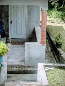 a porch with a white door and a brick pillar at BtC Apartments St Paul's in Saint Paulʼs
