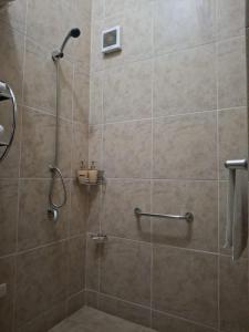 a bathroom with a shower with a glass door at APU MOUNTAIN LODGE CUSCO in Cusco +56 photos