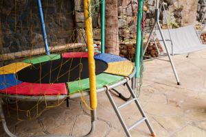 a colorful chair with a net on it at Castelinho Solemar - Suíte Premium com Banheira Privativa e Ar in Praia Grande