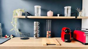 a kitchen with a counter with a toaster and shelves at L'Escale de Pontcarré - Disneyland Paris in Pontcarré