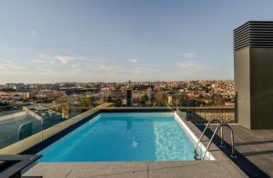 a swimming pool on the roof of a building at New Douro Tower 206 with shared pool and parking in Vila Nova de Gaia