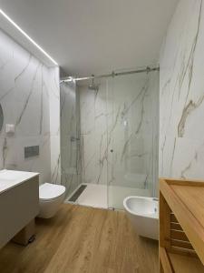 a bathroom with a shower and a toilet and a sink at New Douro Tower 206 with shared pool in Vila Nova de Gaia