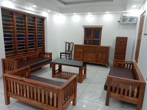 a room with wooden furniture and wooden cabinets at KODIVEED Heritage in Alleppey
