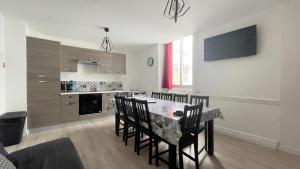 a kitchen with a table and chairs in a room at Résidence Bardon-Perry in Le Mont-Dore