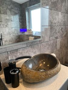 a bathroom with a large bowl sink on a counter at Luxury Portree Cottage Hillside in Portree