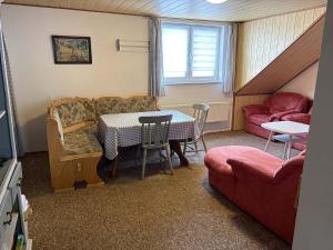 a living room with a table and a couch at U Gerešů in Zadov