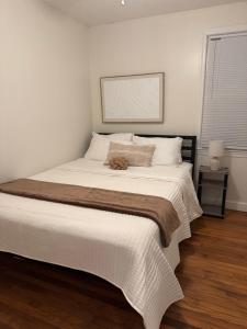 a bedroom with a large bed with a brown blanket at Bright 2BR and1BA Home Near Old Town, Metro, Airport and Potomac Yard in Alexandria
