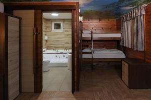 a bathroom with two bunk beds and a tub at Cuki Residence in Mala Ravna Reka +48 photos