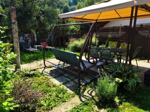 a swing in a garden with a table and chairs at Casa Crissio in Sinaia