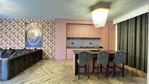 a living room with a table and chairs and a couch at The Pink Pool - Swimming pool in Ras al Khaimah