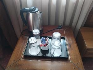 a table with a coffee pot and glasses on it at hotel Sofia in Bansko