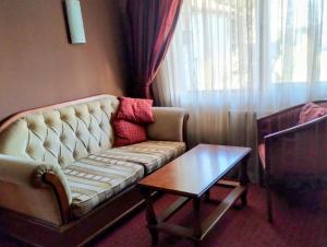 a living room with a couch and a table at hotel Sofia in Bansko +3 photos